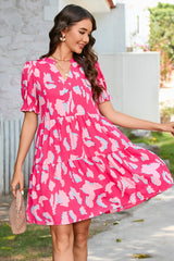 Tiered loose dress with short puff sleeves and pink abstract print