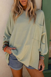 Green ribbed oversized top with rolled up sleeves and chest pocket