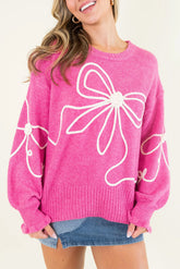 Relaxed sweater with ribbed edge with flowery knot and bright pink cord