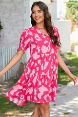Tiered loose dress with short puff sleeves and pink abstract print