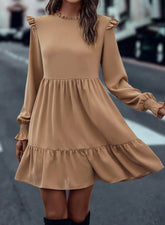 Tiered dress with ruffled shoulders and ruffled collar in light French beige