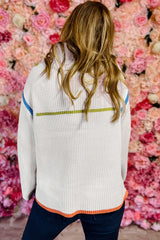 White drooping shoulder sweater and zipper on a quarter of a colored edge