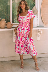 Smocked pink dress with ruffles and brush kick print