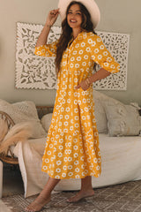 Long dress with collar and sleeve buttons bracelet and yellow flowers print
