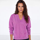 Sudadera rosa en vivo con hombros caídos y un collar de colores lisos