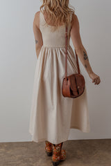 Long beige dress with round neck and bodice *