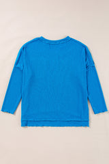 Blue long sleeve v-neck ribbed knit top with exposed seams