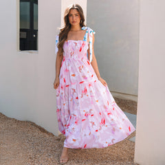 Vestido rosa largo con estampado floral y hombros anudados