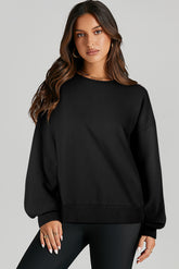 Black solid crew neck sweatshirt with high low hem