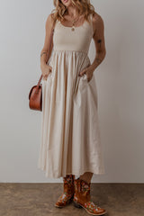 Long beige dress with round neck and bodice *
