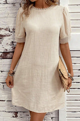 Beige right mini-drock with puffy sleeves and crumpled lace border