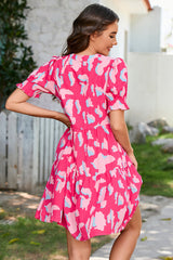 Tiered loose dress with short puff sleeves and pink abstract print