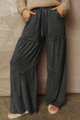 Pantalon large noir délavé à empiècements et coutures apparentes