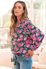 Green blouse with puffy sleeves and tied collar with floral print *