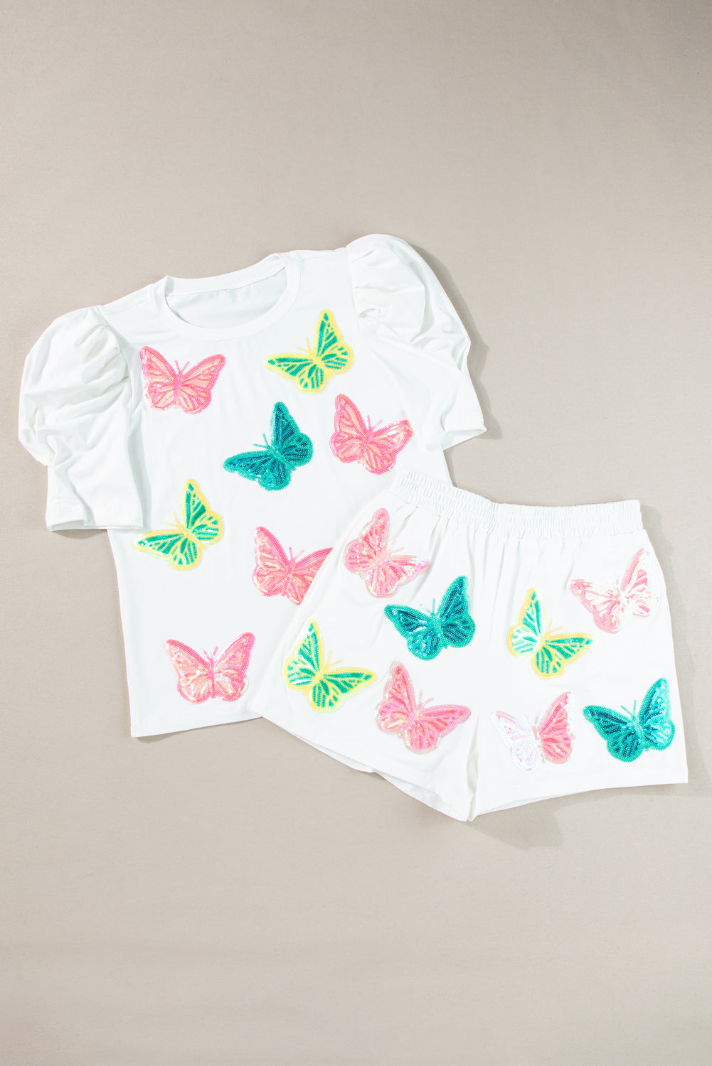 Ensemble haut et short à manches bouffantes et papillon à paillettes colorées blanches