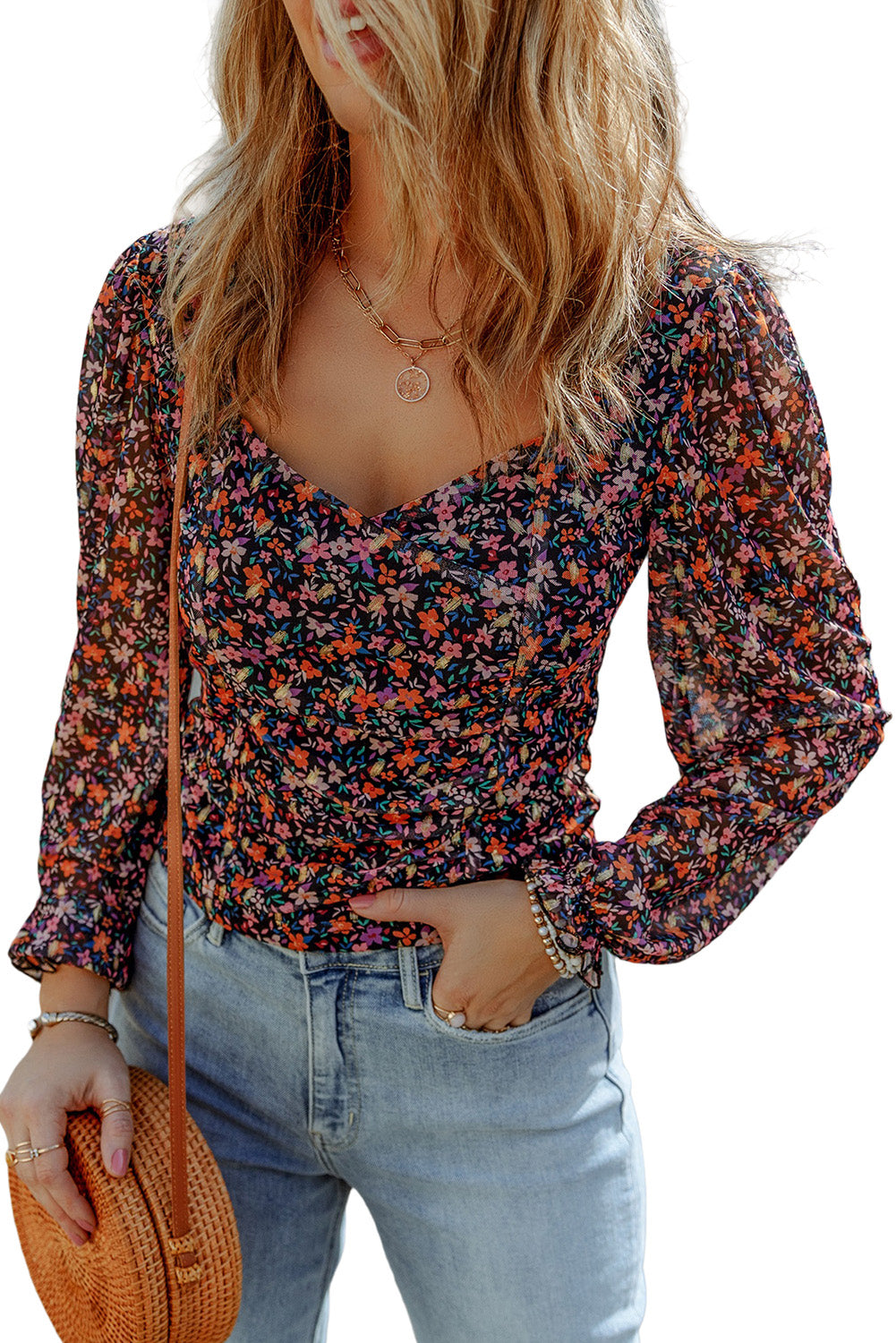 Blouse florale noire à col en V et manches bouffantes