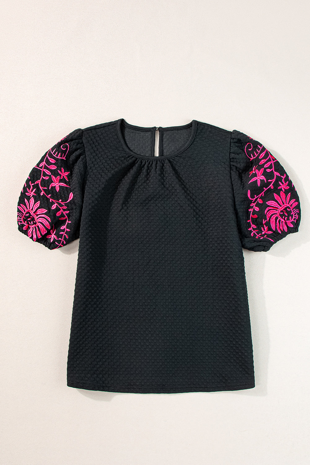 Black t-shirt with puffy textured sleeves embroidered with flowers