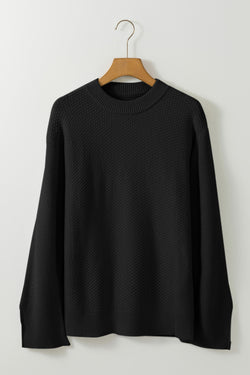 Large black sweater in plain textured knitting, split cuff*