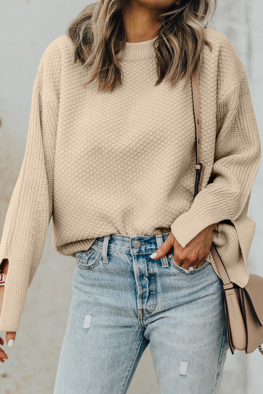 Loose-fitting parchment textured knit sweater with slit cuffs and dropped shoulders