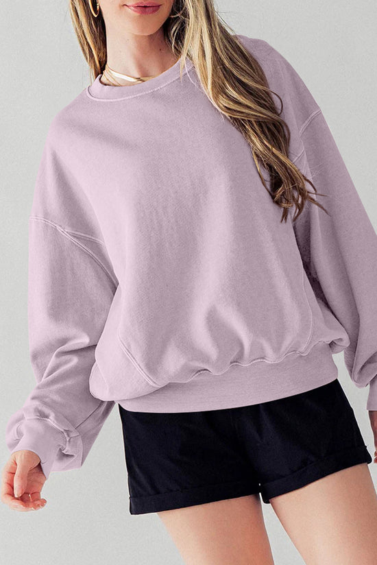 Dropped shoulder sweatshirt with batwing sleeves and exposed seams and orchid petals