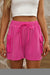 Large shorts with bright pink cargo pocket