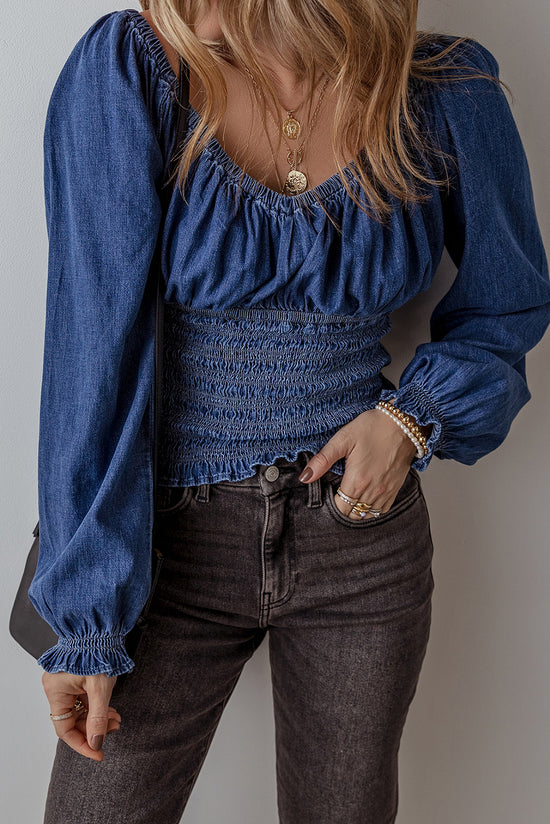 Smocked dark blue jeans blouse with ruffles and puffy sleeves in V -neck