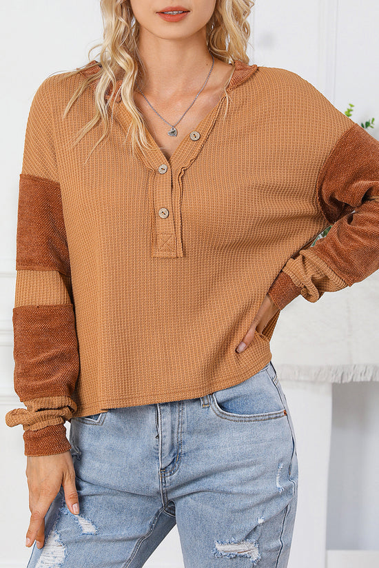 Waffle knit henley top with exposed seams and orange contrast patches