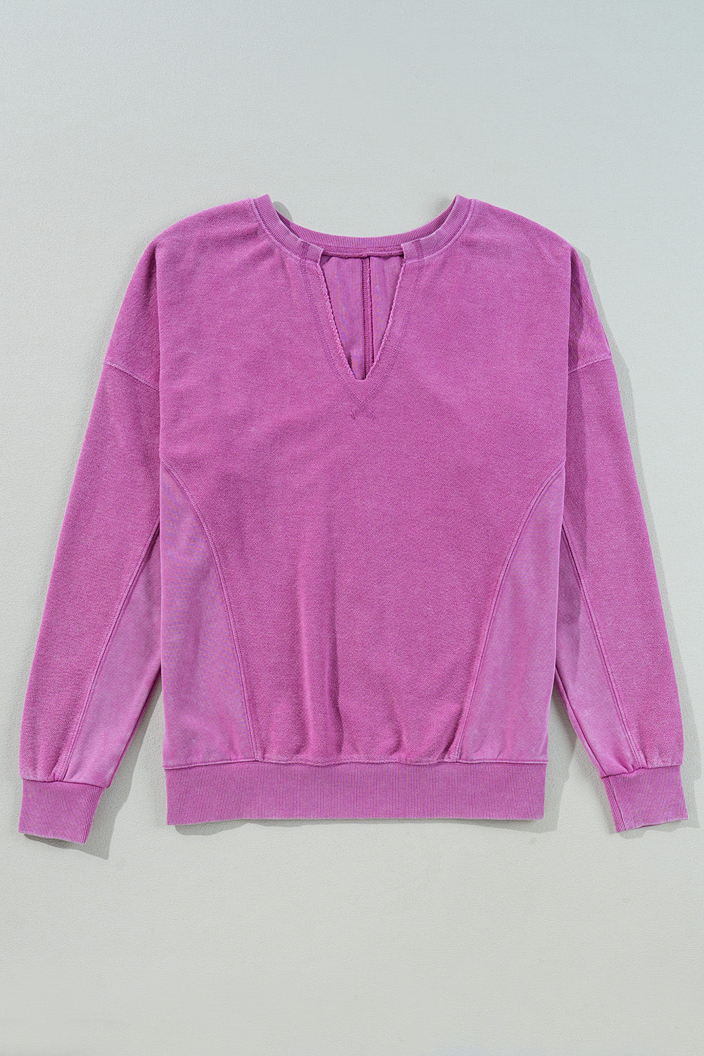 Hot pink sweatshirt with dropped shoulders and solid color notched collar