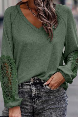 Green top with raglan sleeves and crochet lace patch