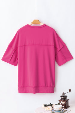 High tunic with wide sleeves and buttoned collar with apparent red pink seams