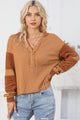 Waffle knit henley top with exposed seams and orange contrast patches