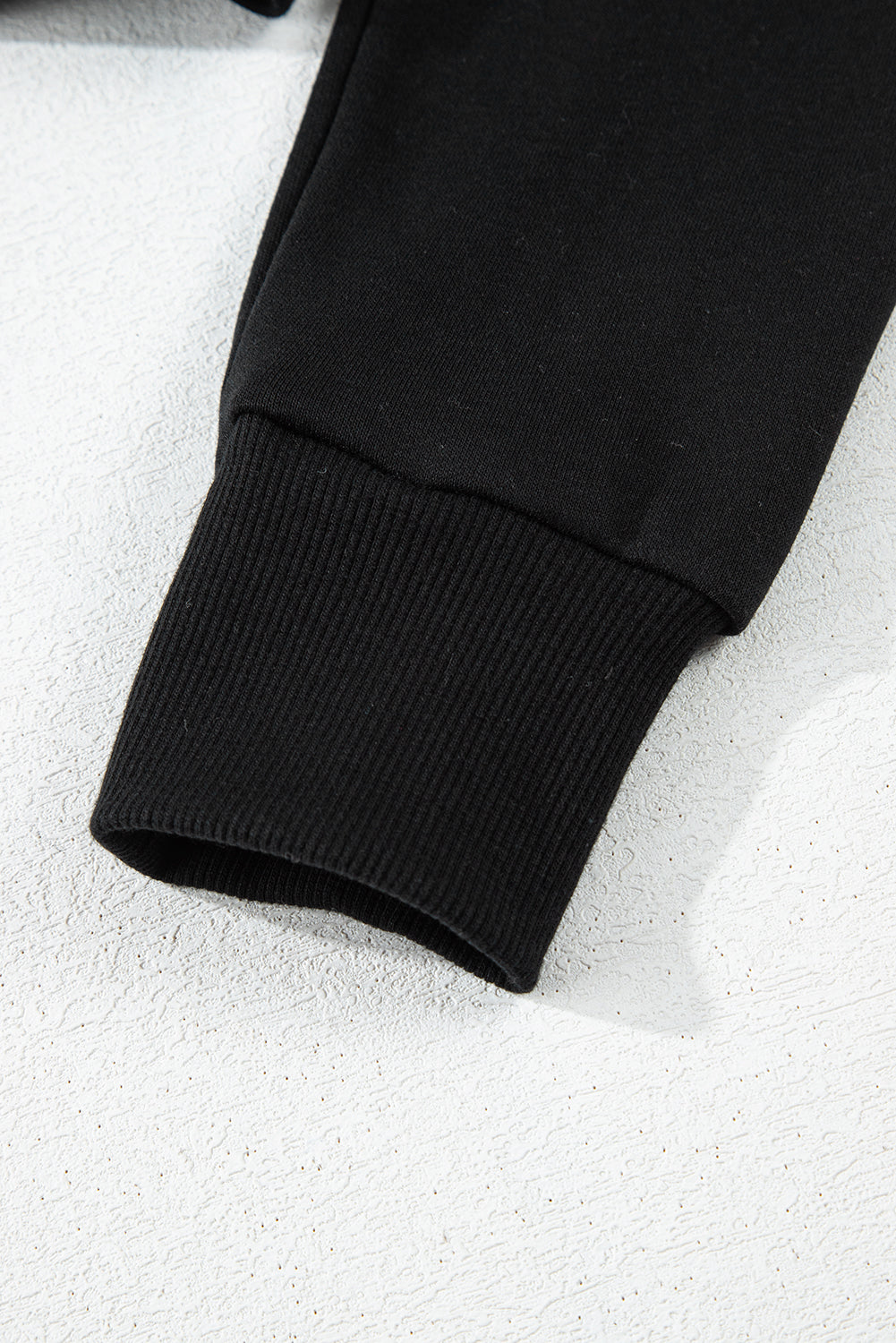 Short black hooded plain with drooping shoulders *