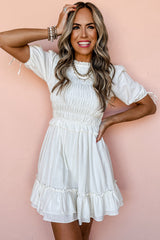 White ruffled and smocked mini dress, short sleeves, tie