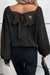 Black sweater with lantern sleeves, V-neck, knot at the back