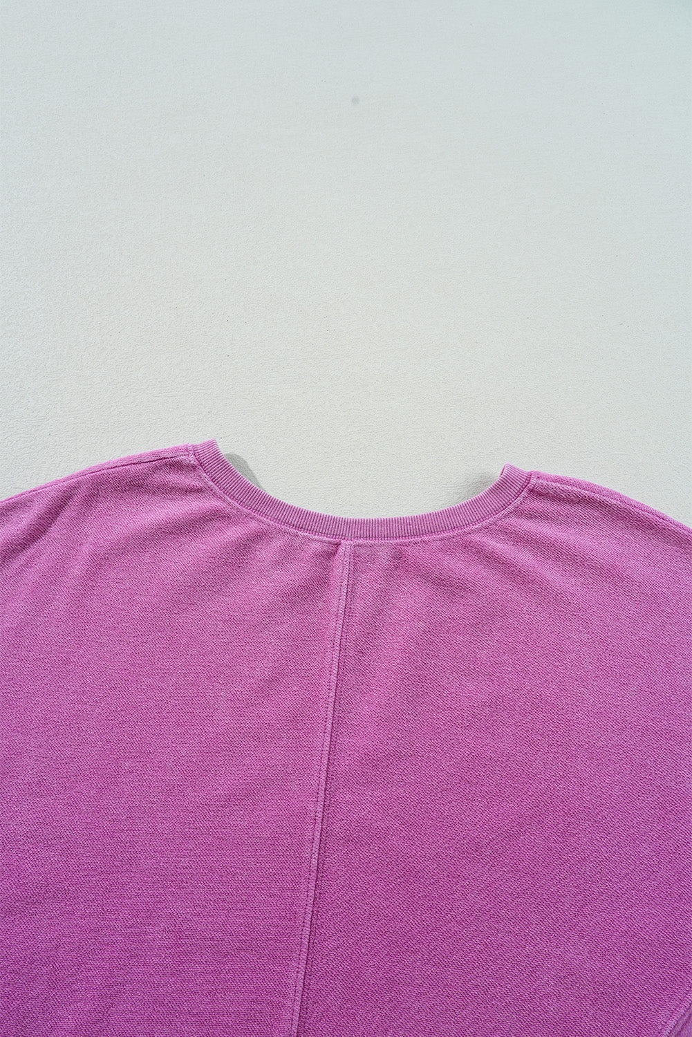 Hot pink sweatshirt with dropped shoulders and solid color notched collar