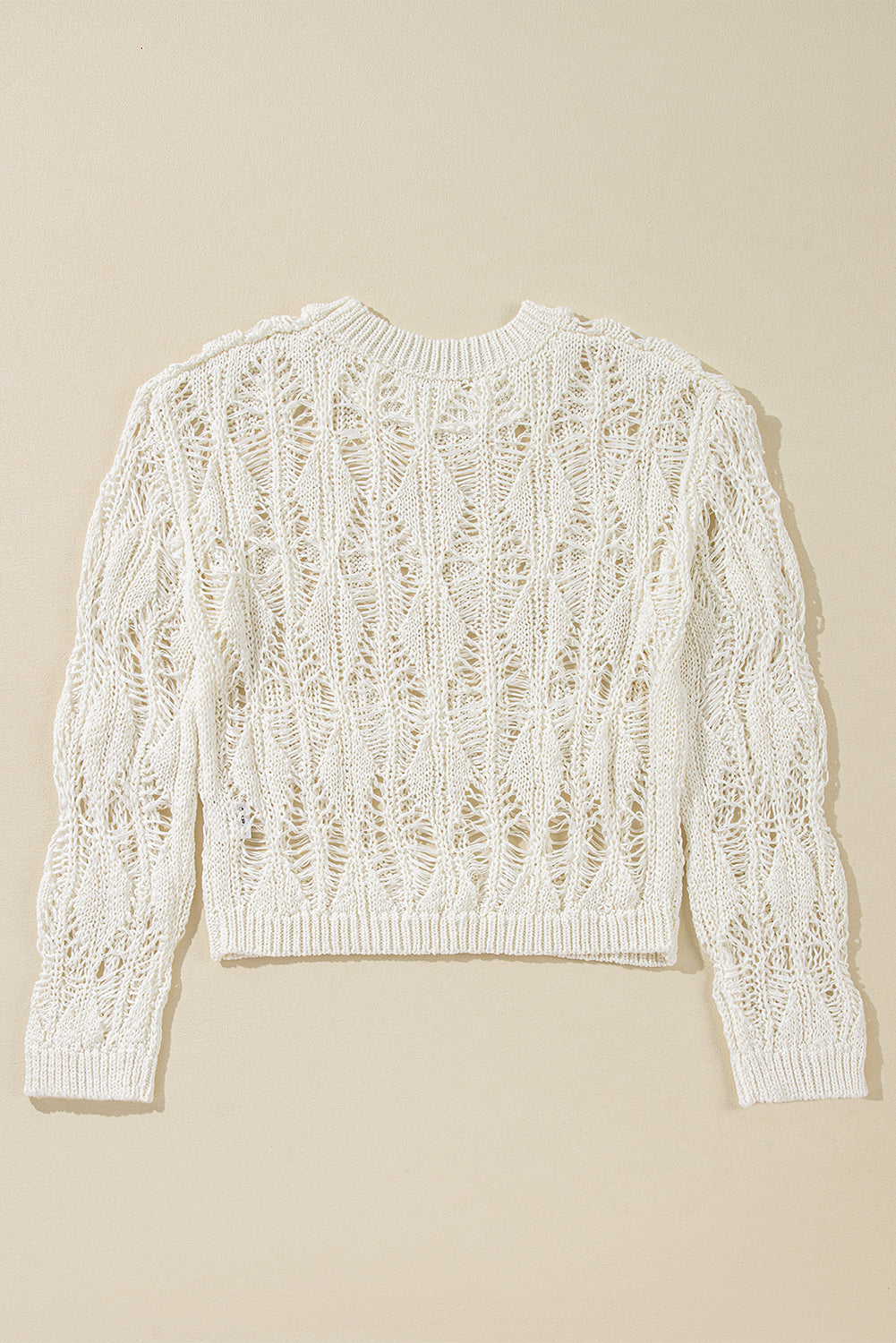 Pull ample blanc à col ras du cou et découpes en crochet