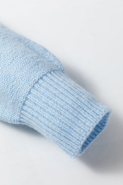 Light blue knitted sweater with ribbed edges with flowers pattern