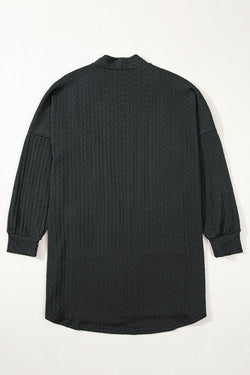 Cardigan noir ouvert sur le devant avec poches latérales en tricot texturé