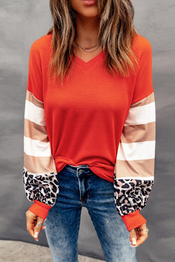 Orange top with lantern sleeves and leopard stripes