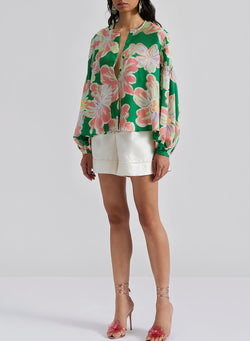 Large folded shirt with puffy sleeves and green floral print button