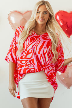 Oversize red blouse with abstract print, V-neck, bat handles