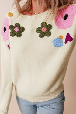 Beige knitted sweater with ribbed edges with flower pattern