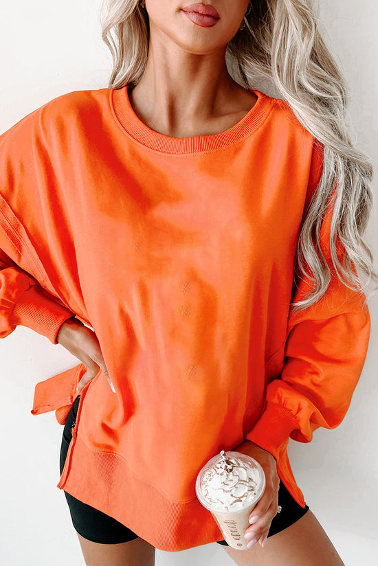 Crew neck sweatshirt with dropped shoulders and exposed seams with slits