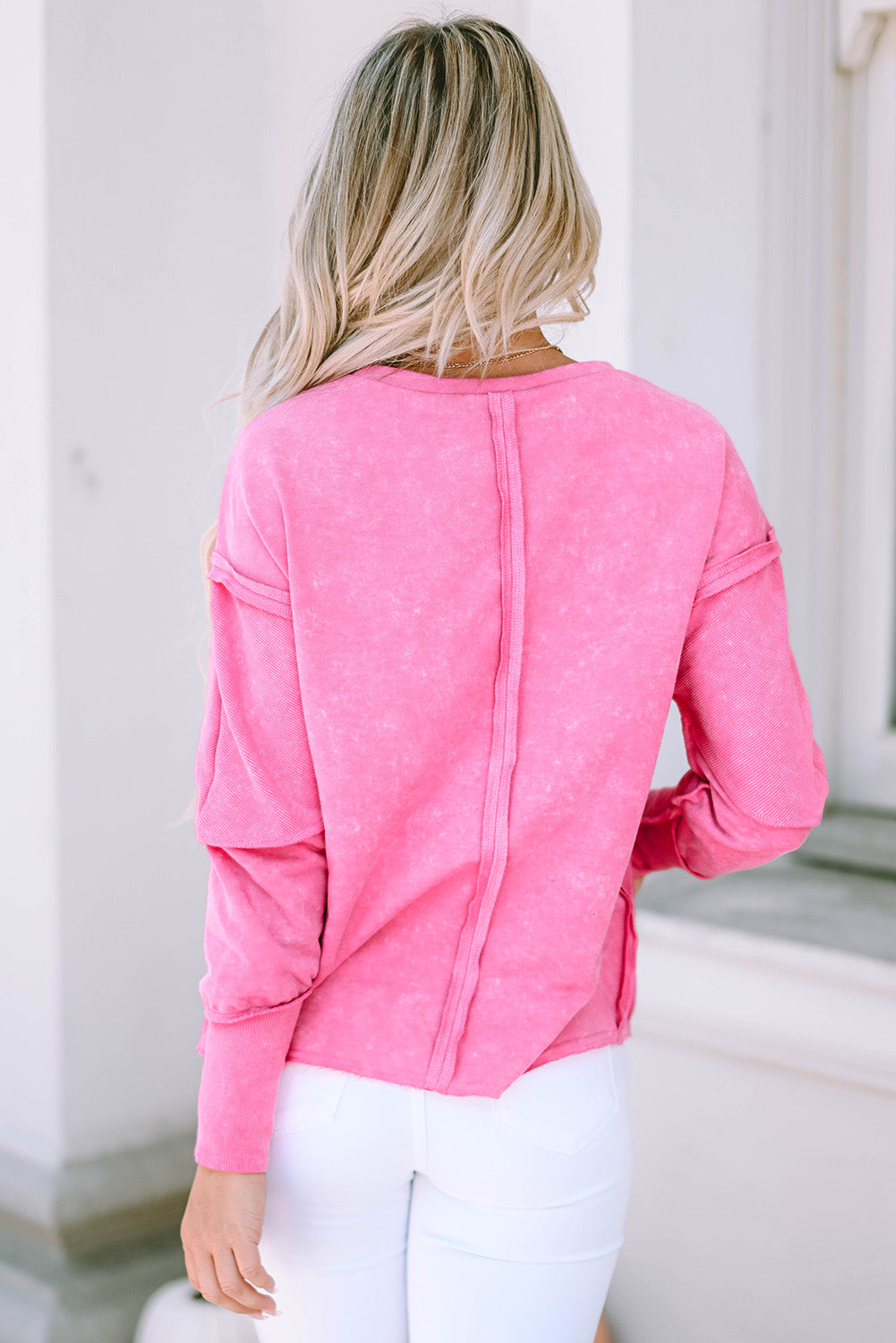 Pink sweatshirt with raw edges, exposed seams, up and down