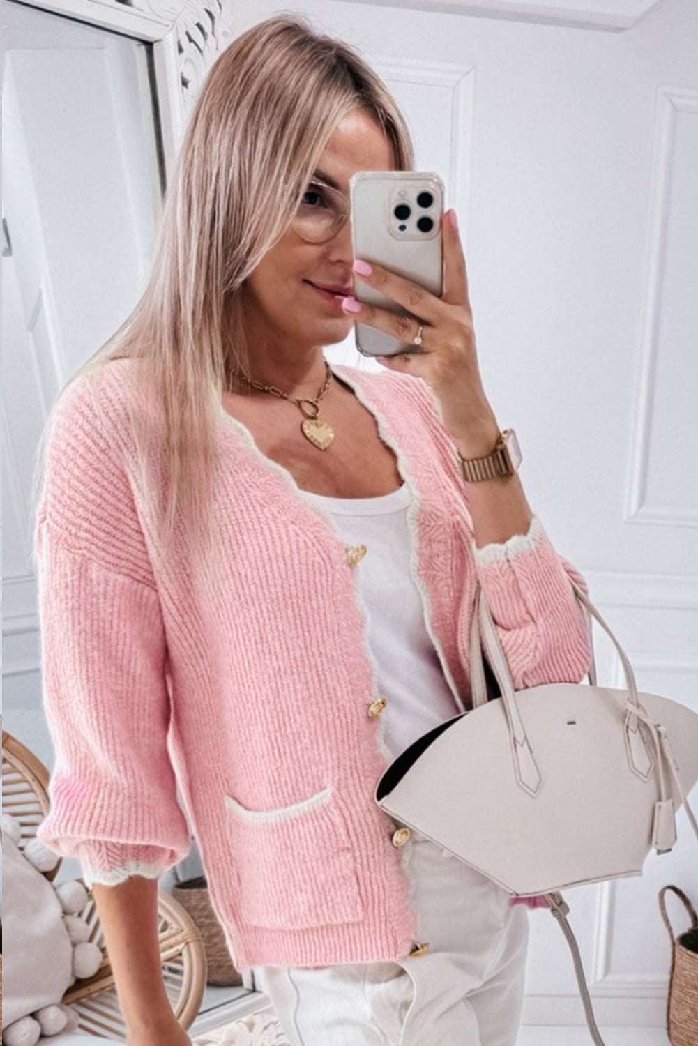 Pink ribbed knit button-up cardigan with side pockets and scalloped edges