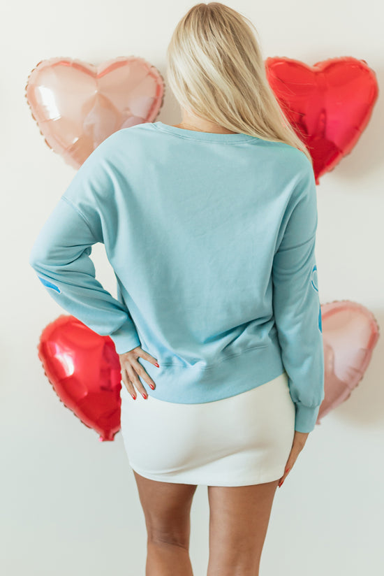 Over-dimensional sequined sweatshirt and butterfly knot with drooping shoulder