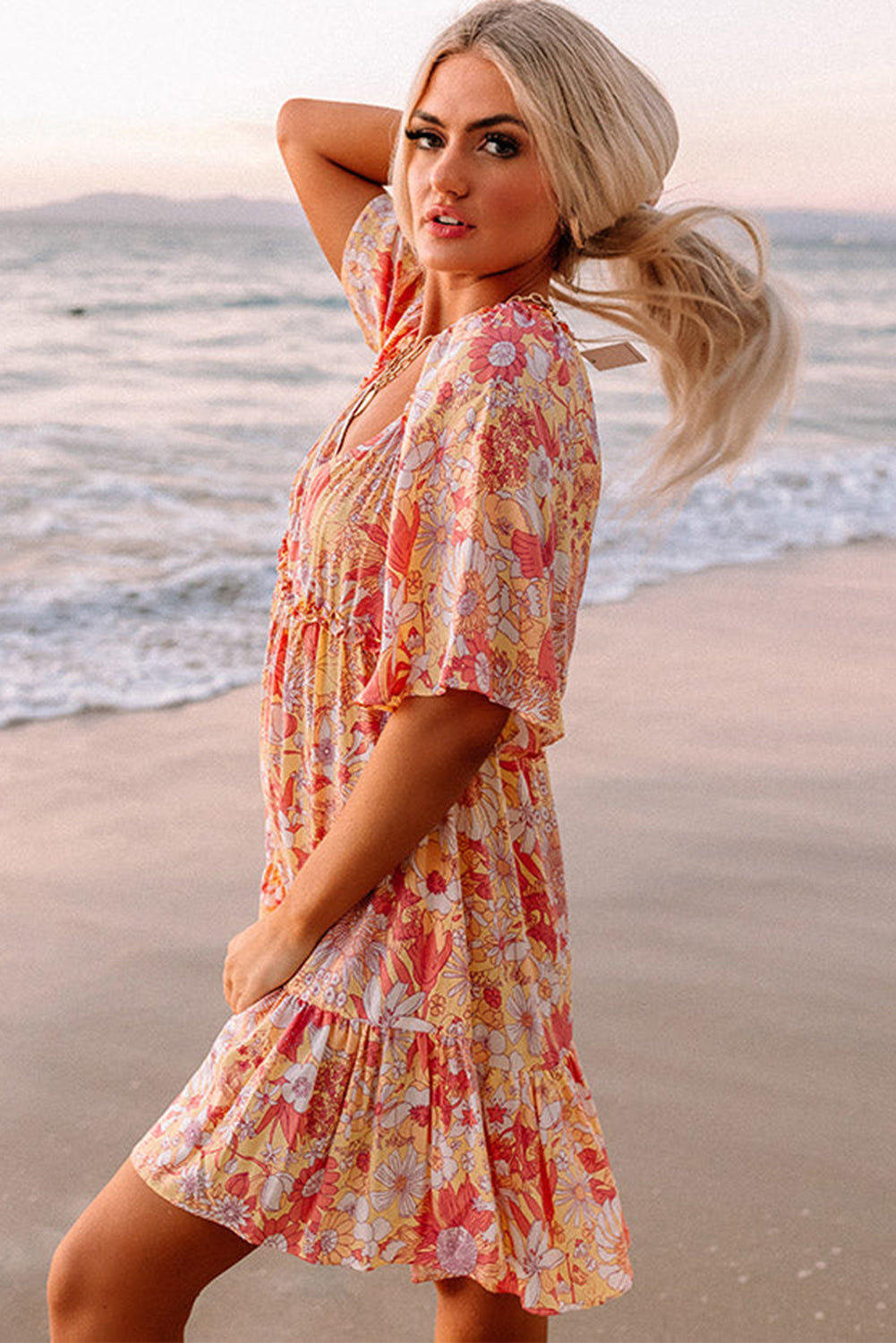 Orange floral dress with wide, flowing sleeves