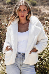 Beige jacket in faux fur with buttoned pockets and reverse neck