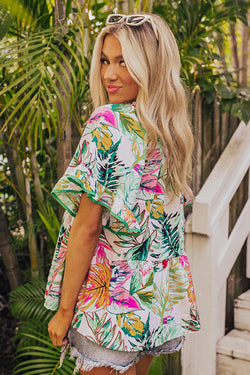 White blouse with short sleeves and ruffles with tropical floral print