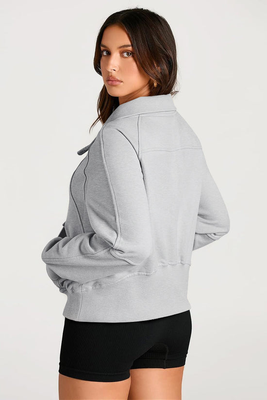 Light gray sweatshirt with stand-up collar and kangaroo pocket with quarter-turn zip